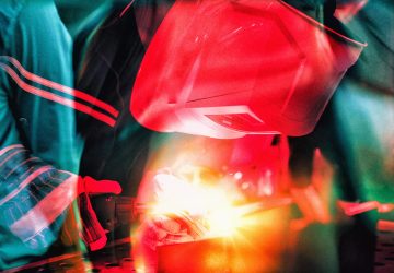 Welder with protective mask welding metal